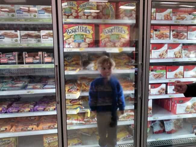 The Joys Of Shopping With Kids standing in freezer