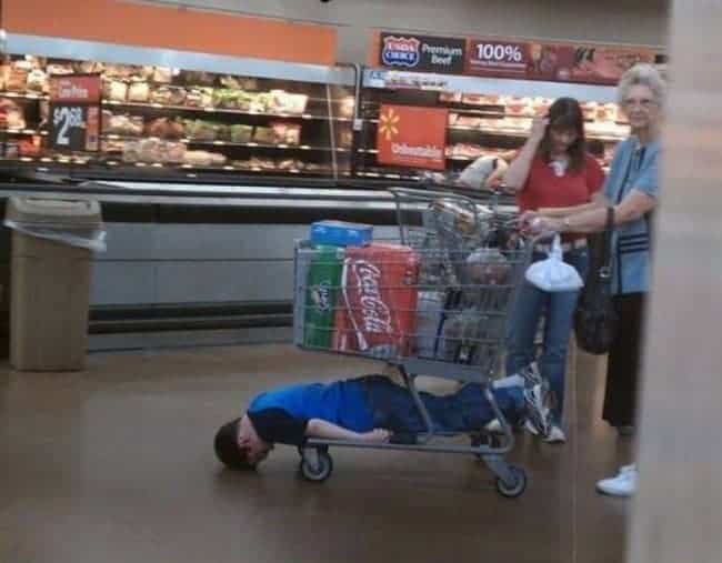 The Joys Of Shopping With Kids underneath trolley